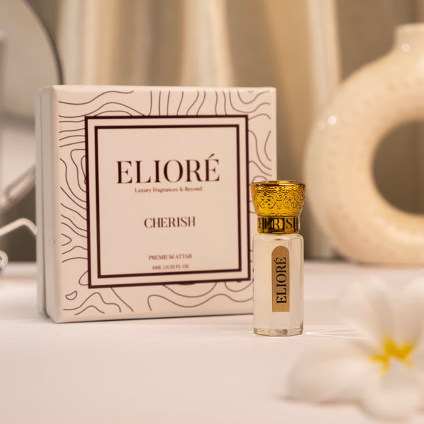 Cherish by Elioré premium attar perfume bottle with luxury packaging in an elegant warm-toned minimal fragrance setup.