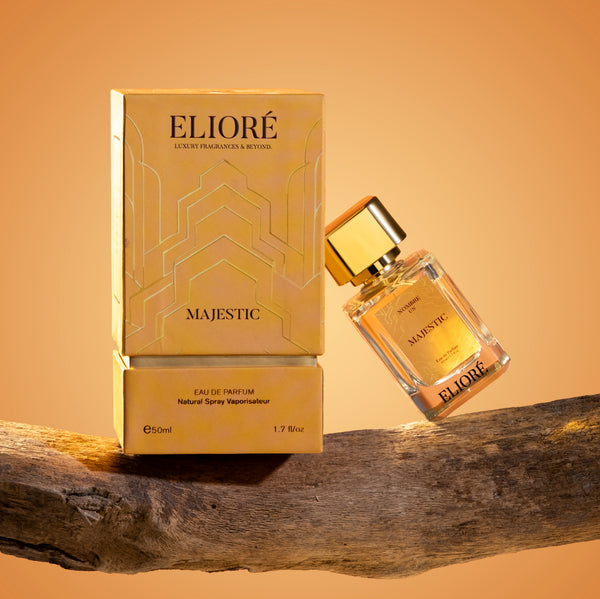 Eliore Majestic perfume bottle and packaging on a wooden surface with a warm background