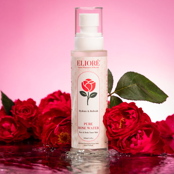 Pure Rose Water Mist by Elioré Essentials surrounded by fresh red roses with luxury pink aesthetic and hydrating skincare presentation.