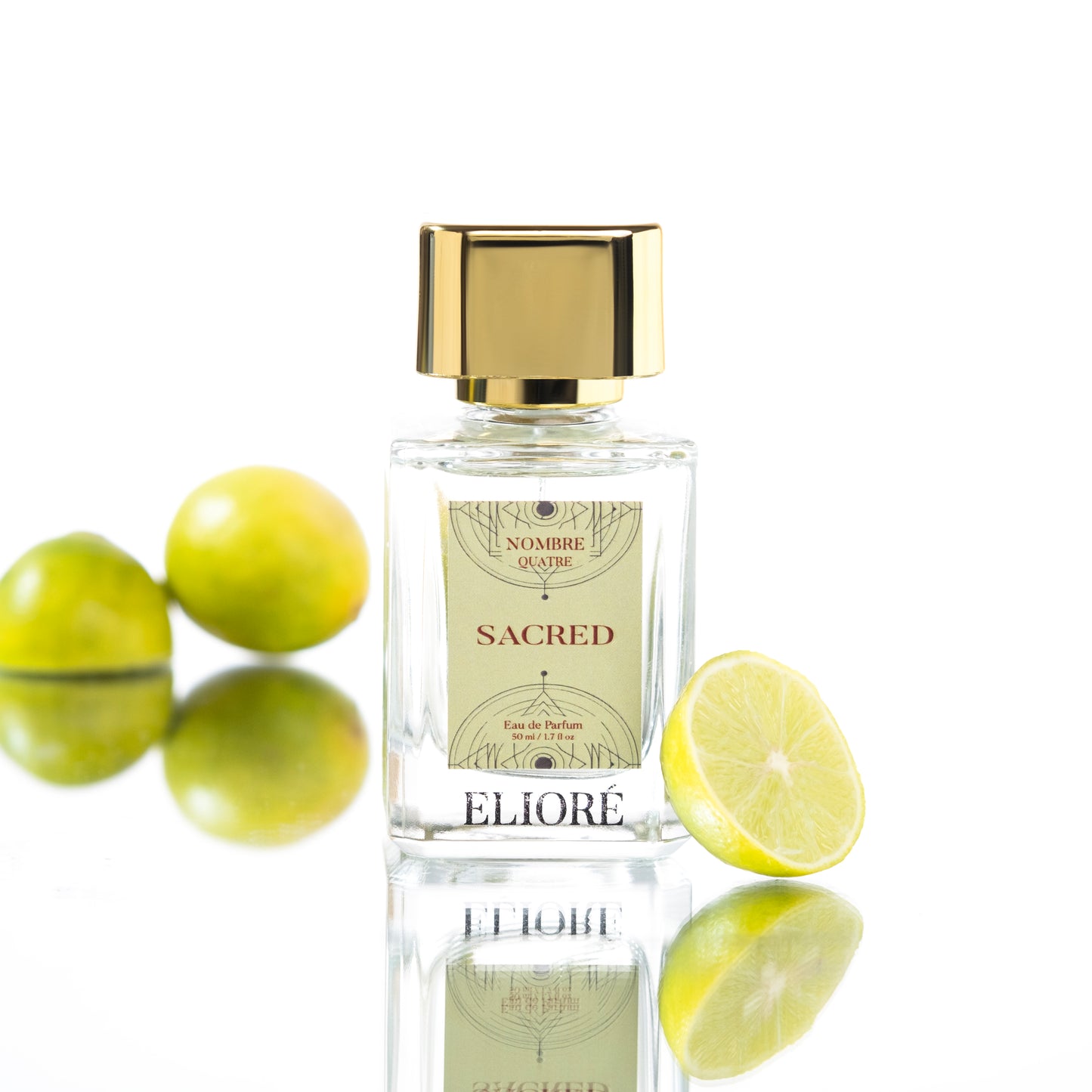 Perfume bottle labeled 'Eliore Sacred' with lemons and green fruits on a white background