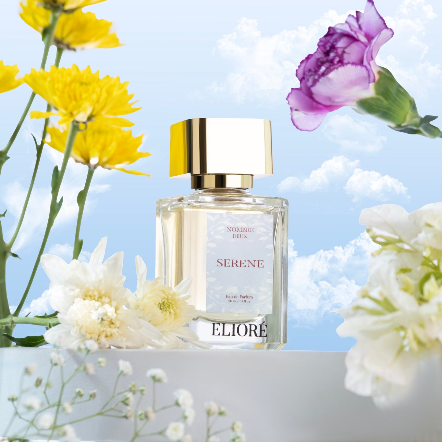 Eliore Serene perfume bottle with flowers on a light blue background